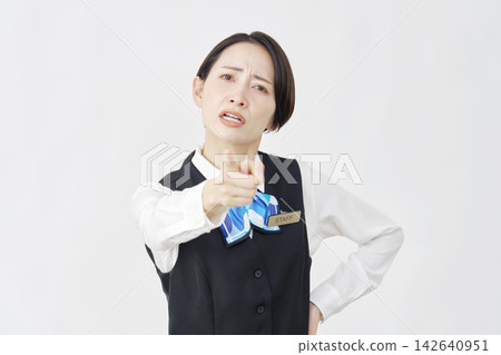 Female staff member giving instructions (receptionist/bank employee) against a white background. Female staff member giving instructions (receptionist/bank employee) against a white background. 142640951