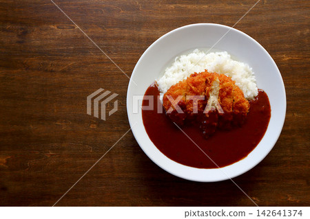 Chicken cutlet curry rice viewed from directly above the table background. Chicken cutlet curry rice viewed from directly above the table background. 142641374