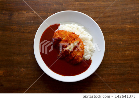 Chicken cutlet curry rice viewed from directly above the table background. Chicken cutlet curry rice viewed from directly above the table background. 142641375