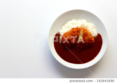 Chicken cutlet curry rice viewed from directly above against a white background. Chicken cutlet curry rice viewed from directly above against a white background. 142641690