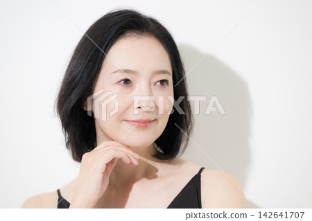 Beauty of a woman in her 50s with beautiful skin and a natural expression: Serious expression, skincare, and anti-aging. Beauty of a woman in her 50s with beautiful skin and a natural expression: Serious expression, skincare, and anti-aging. 142641707