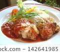 Herb-roasted chicken with cheese and tomato sauce 142641985