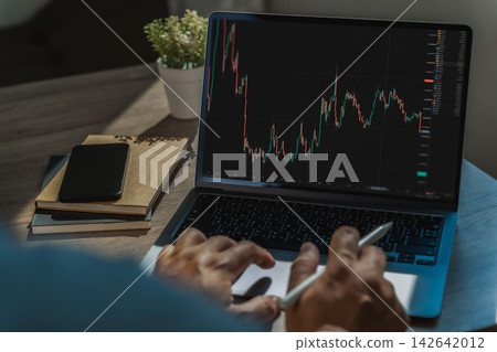 Businessman reviewing candlestick market Businessman reviewing candlestick market 142642012