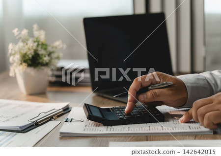 Businessman reviewing financial documents Businessman reviewing financial documents 142642015