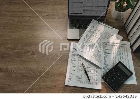 Financial documents, laptop, calculator arranged Financial documents, laptop, calculator arranged 142642019