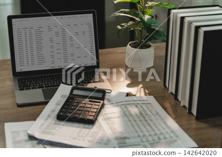 Laptop spreadsheet with calculator and financial Laptop spreadsheet with calculator and financial 142642020