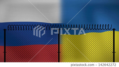 Showing chainlink diamondmesh fence featuring razor wire and posts at border, with flags meeting Showing chainlink diamondmesh fence featuring razor wire and posts at border, with flags meeting 142642272