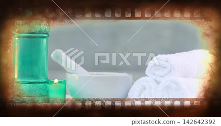 White mortar pestle sitting with towels and green candle, camera zooming animating vignette for spa White mortar pestle sitting with towels and green candle, camera zooming animating vignette for spa 142642392
