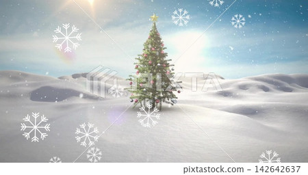 Standing decorated Christmas tree sparkling on snowfield, with star topper, sun flare Standing decorated Christmas tree sparkling on snowfield, with star topper, sun flare 142642637
