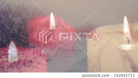 Blending three pillar candles glowing over snowy country road, showing flames and tire tracks Blending three pillar candles glowing over snowy country road, showing flames and tire tracks 142642713