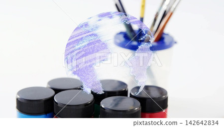 Showing six paint jars blackcap on art table, holo globe floating above blue-rim holder and brushes Showing six paint jars blackcap on art table, holo globe floating above blue-rim holder and brushes 142642834