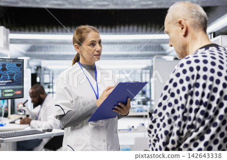 Female specialist reviewing chemical reaction on patient vitals in clinical procedure, testing new drug and studying treatment outcomes. Research for healthcare and toxicology innovation. Female specialist reviewing chemical reaction on patient vitals in clinical procedure, testing new drug and studying treatment outcomes. Research for healthcare and toxicology innovation. 142643338