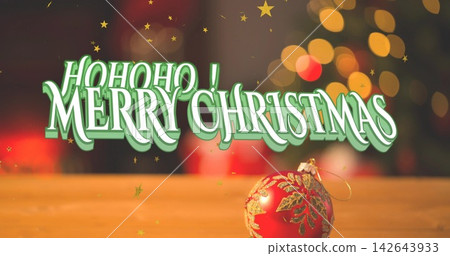 Displaying centered 3D holiday text dominating on wooden tabletop, with red glass ornament nearby Displaying centered 3D holiday text dominating on wooden tabletop, with red glass ornament nearby 142643933