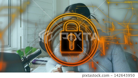 Holding mug, woman wearing gray chunky sweater sitting at home desk, with mic and padlock overlay 142643950