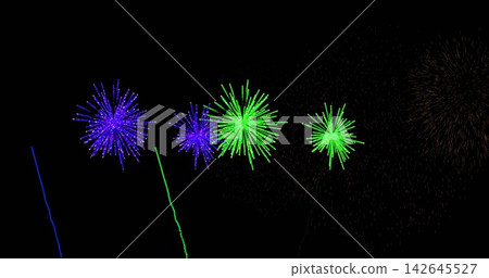 Night fireworks bursting in dark sky, showing purple and green bursts with blue trails and sparks Night fireworks bursting in dark sky, showing purple and green bursts with blue trails and sparks 142645527