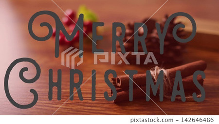 Displaying decorative overlay reading MERRY CHRISTMAS on wooden tabletop, showing tied cinnamon Displaying decorative overlay reading MERRY CHRISTMAS on wooden tabletop, showing tied cinnamon 142646486