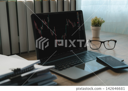 Investor analyzing stock chart Laptop analysis graph stock market trading candlestick stock charts , financial market analysis, trading research and digital investment monitoring. Investor analyzing stock chart Laptop analysis graph stock market trading candlestick stock charts , financial market analysis, trading research and digital investment monitoring. 142646681