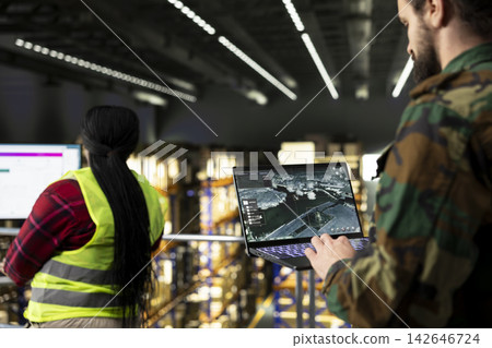 Army soldier, advanced military surveillance, software in facility, aerial drone monitoring and threat detection on laptop. Armed forces logistics, infrastructure and strategic coordination. 142646724