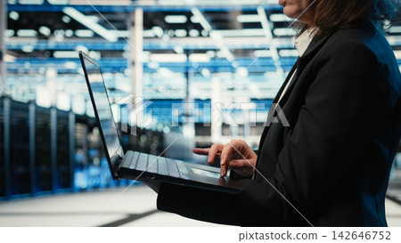 Close up of laptop software used by data center admin to troubleshoot supercomputers issues. Server farm employee analyzing system logs with notebook to resolve electronics errors 142646752