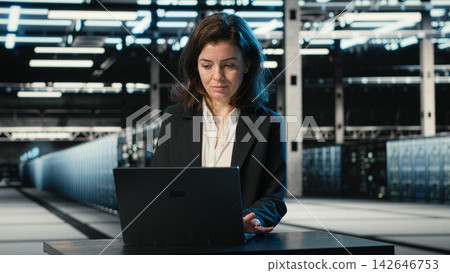 Typing on keyboard, laptop and engineer in data center troubleshooting supercomputers connectivity issues. Fixing gear errors, notebook program and expert in server hub analyzing system logs Typing on keyboard, laptop and engineer in data center troubleshooting supercomputers connectivity issues. Fixing gear errors, notebook program and expert in server hub analyzing system logs 142646753
