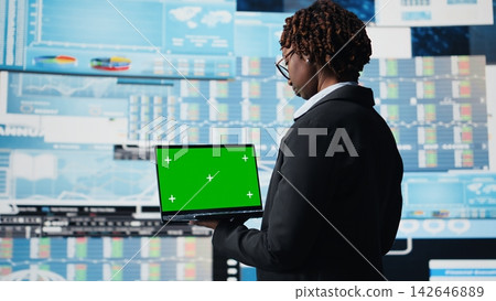Business specialist using green screen laptop to review performance dashboards metrics. Management executive evaluating annual report data using chroma key notebook, camera A Business specialist using green screen laptop to review performance dashboards metrics. Management executive evaluating annual report data using chroma key notebook, camera A 142646889