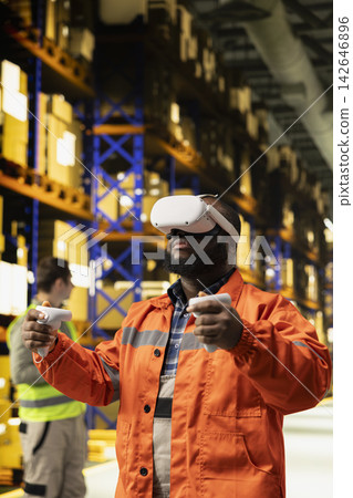Black personnel using virtual reality headset to improve order fulfillment, using immersive simulation to lift cardboard boxes in metaverse. Modern supply chain technology, 3D automation. Black personnel using virtual reality headset to improve order fulfillment, using immersive simulation to lift cardboard boxes in metaverse. Modern supply chain technology, 3D automation. 142646896