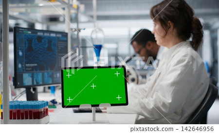 Medical laboratory technician using isolated screen tablet for DNA data analysis, supporting clinical research. Woman studying genomics information for human health study using chroma key device Medical laboratory technician using isolated screen tablet for DNA data analysis, supporting clinical research. Woman studying genomics information for human health study using chroma key device 142646956