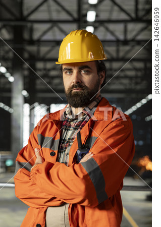 Portrait, mechanical engineer, monitoring performance, manufacturing process, production hall. Man works in heavy industry environment with steel work in modern large-scale facility. Portrait, mechanical engineer, monitoring performance, manufacturing process, production hall. Man works in heavy industry environment with steel work in modern large-scale facility. 142646959