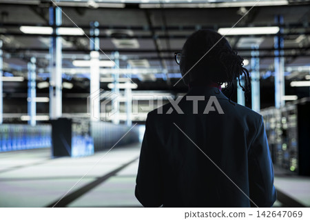 Data center manager overseeing IT infrastructure, ensuring compliance with industry standards. Server hub worker monitoring system performance and implementing efficiency optimizations Data center manager overseeing IT infrastructure, ensuring compliance with industry standards. Server hub worker monitoring system performance and implementing efficiency optimizations 142647069