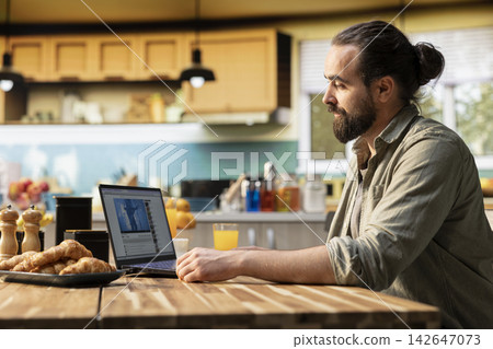 One person viewing live music concert video on streaming platform, laptop at home. Modern digital lifestyle, online entertainment, recorded content and clips on social network websites. One person viewing live music concert video on streaming platform, laptop at home. Modern digital lifestyle, online entertainment, recorded content and clips on social network websites. 142647073