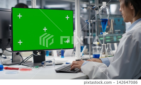 Lab technician using green screen computer for DNA data analysis, supporting clinical diagnostics research. Scientist studying genomics information for human health study using mockup PC, camera B Lab technician using green screen computer for DNA data analysis, supporting clinical diagnostics research. Scientist studying genomics information for human health study using mockup PC, camera B 142647086