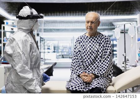 Scientist in hazmat suit studies a patient with an infectious disease, using pharmacology and microbiology techniques to identify symptoms and develop effective antiviral treatments. Scientist in hazmat suit studies a patient with an infectious disease, using pharmacology and microbiology techniques to identify symptoms and develop effective antiviral treatments. 142647153