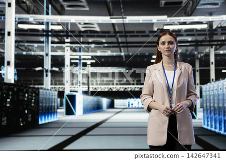 Portrait of data center cybersecurity expert protecting against network malware threats. Server farm female engineer auditing systems for virus vulnerabilities and computer bugs 142647341