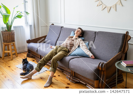 Exhausted woman lying on sofa at home with fatigue, weakness, apathy and symptoms of depression Exhausted woman lying on sofa at home with fatigue, weakness, apathy and symptoms of depression 142647571