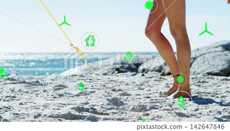 Standing woman in swimsuit-bottom on sand near blue sea, yellow rope, green icons, copy space 142647846