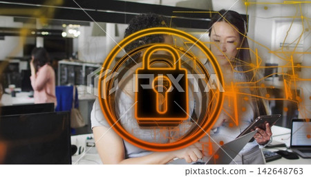Working coworkers in business clothes pointing at laptop and tablet in office with orange lock icon Working coworkers in business clothes pointing at laptop and tablet in office with orange lock icon 142648763