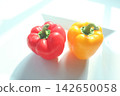 A white background with vibrant red and yellow bell peppers. 142650058