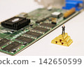 The image of technology and asset value combining electronic circuit boards and gold bars. 142650599