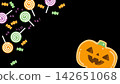 Halloween pumpkin icing cookies and lots of candy (black background) 142651068