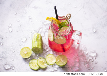 cocktail tea with mojito lemon lime and cucumber, Colorful summer drink juicy red pink 142651383