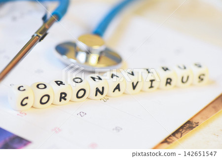 Coronavirus words and stethoscope on calendar - COVID-19 coronavirus spread influenza medical crisis pandemic public health risk prevention Coronavirus words and stethoscope on calendar - COVID-19 coronavirus spread influenza medical crisis pandemic public health risk prevention 142651547
