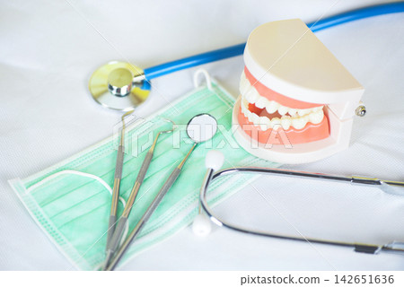 dentist tools with bamboo toothbrush dentures dentistry instruments and dental hygienist checkup concept with teeth model and mouth mirror oral health dentist tools with bamboo toothbrush dentures dentistry instruments and dental hygienist checkup concept with teeth model and mouth mirror oral health 142651636