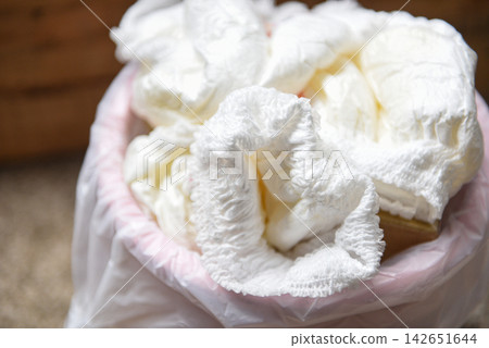 Diapers waste - dirty diapers in a garbage pail Disposing of used baby nappies 142651644