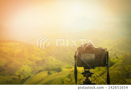 Digital camera professional / camera on tripod with view of mountain nature on background - Take photos Shooting nature Digital camera professional / camera on tripod with view of mountain nature on background - Take photos Shooting nature 142651654
