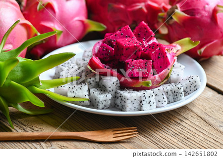 dragon fruit slice on white plate with pitahaya background, fresh white and pink red purple dragon fruit tropical in the asian thailand healthy fruit concept dragon fruit slice on white plate with pitahaya background, fresh white and pink red purple dragon fruit tropical in the asian thailand healthy fruit concept 142651802