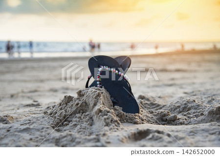 flip flops on beach with sandy beach sunset and ocean sea background flip flops on beach with sandy beach sunset and ocean sea background 142652000