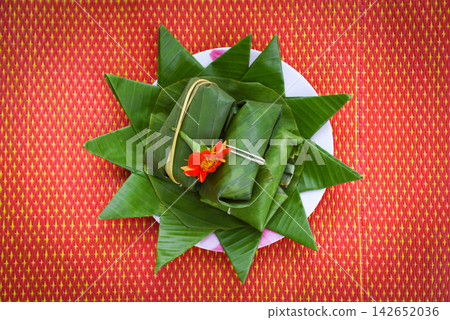 food and dessert thai wrapped in banana leaf on plate food and dessert thai wrapped in banana leaf on plate 142652036
