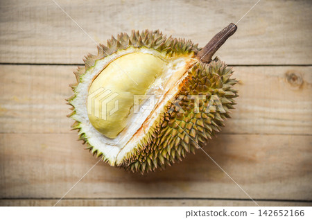 Durian riped / Fresh durian peel tropical fruit on wooden background on summer Durian riped / Fresh durian peel tropical fruit on wooden background on summer 142652166
