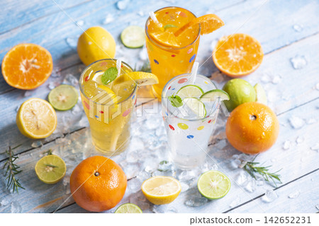 Fresh fruit on ice homemade cocktail tea with mojito lemon lime orange rosemary and mint leaf, Colorful summer drink juicy, Exotic summer drinks refreshing variety of cold drinks glasses 142652231