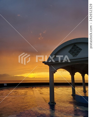 A gazebo bathed in the sunset over Miyagi coast after the rain. A gazebo bathed in the sunset over Miyagi coast after the rain. 142652329